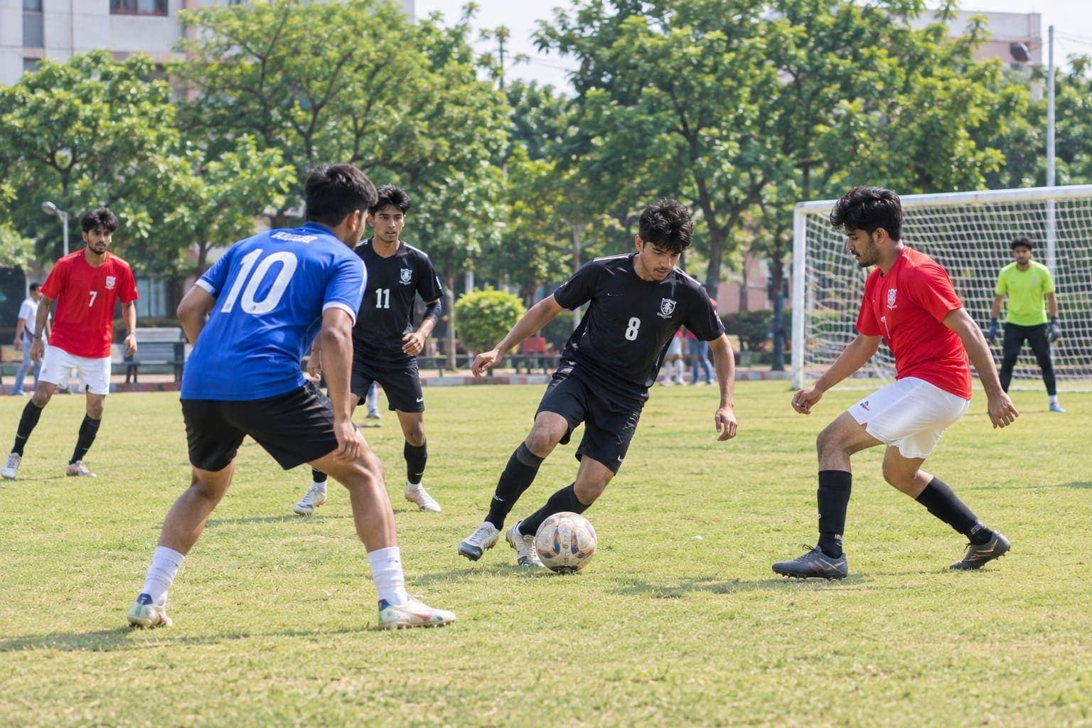 Students playing football on the ground